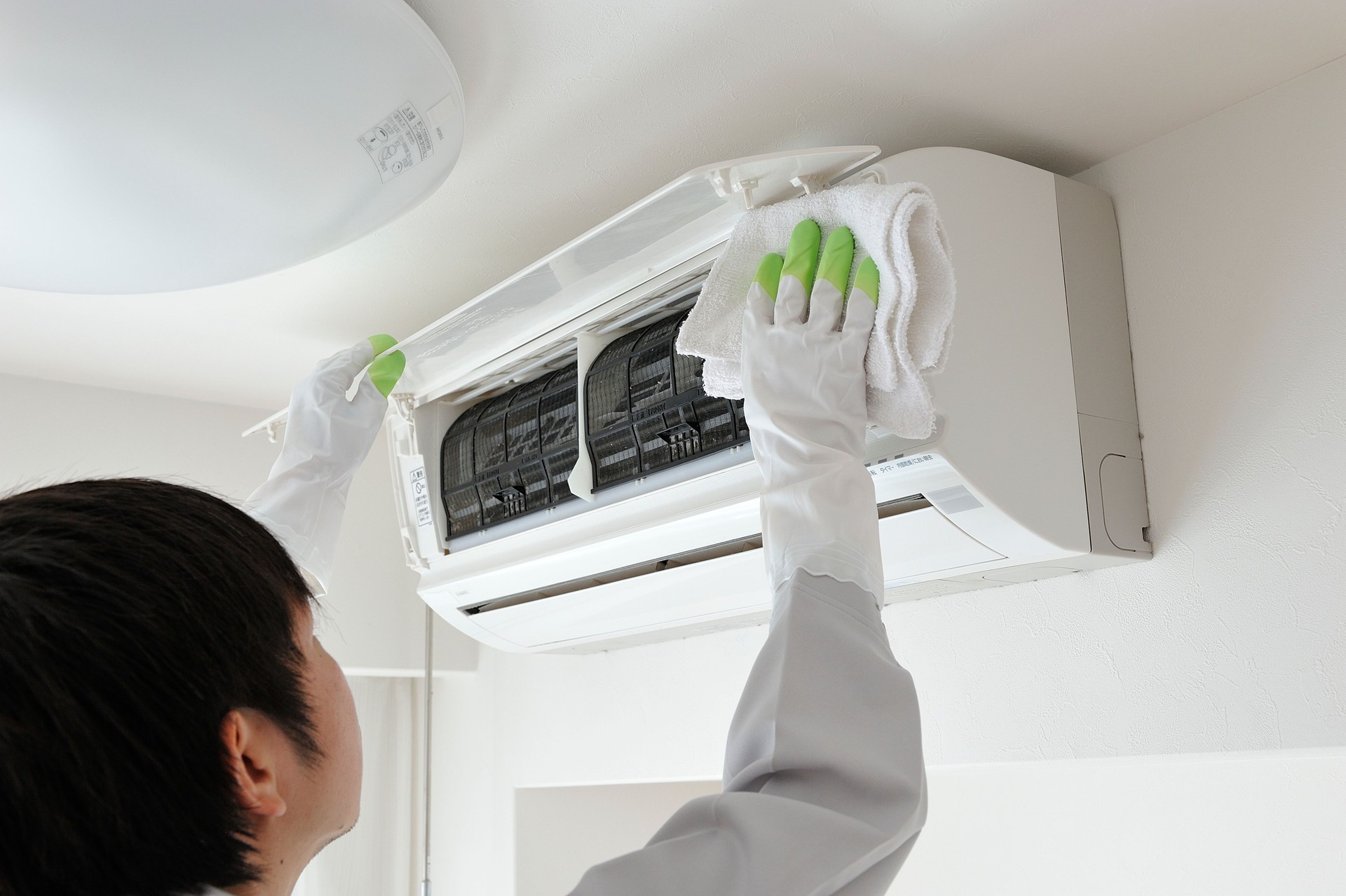 Japanese man dressed for work crews to clean the air conditioner